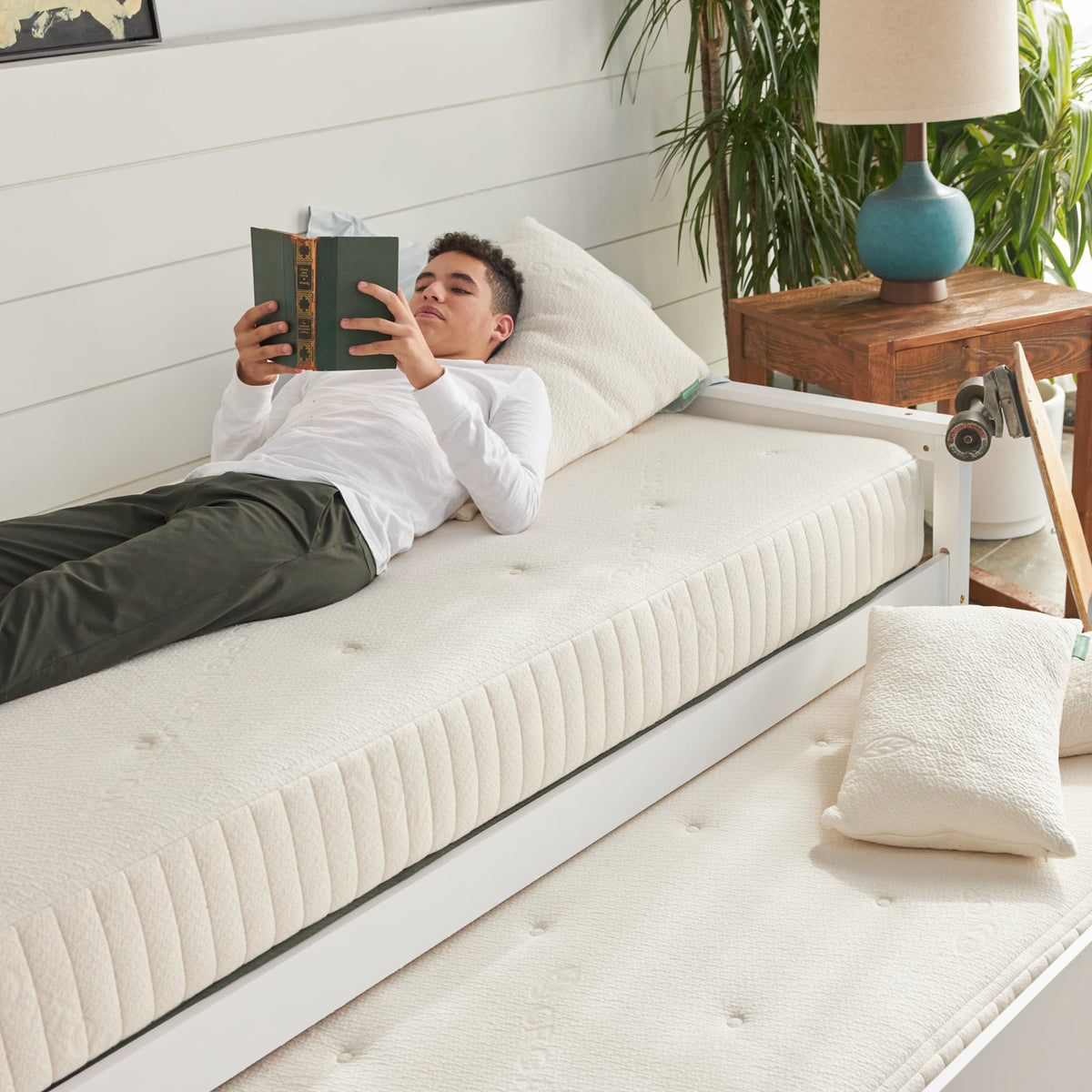 Avocado Eco Organic Kids Mattress shown with an older child; bed and bedding sold separately